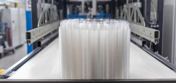 Thays coming out of thermoform machine ANL Packaging trays thermoform machine